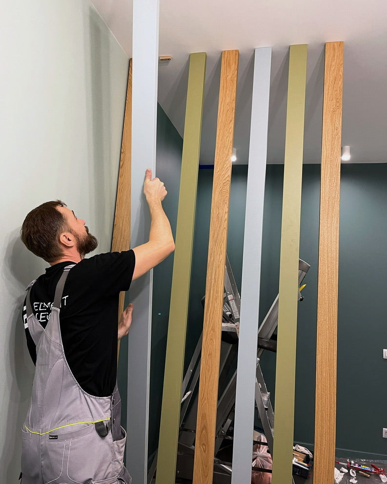 Andrew checking the spacing on a mixed oak and painted slat divider