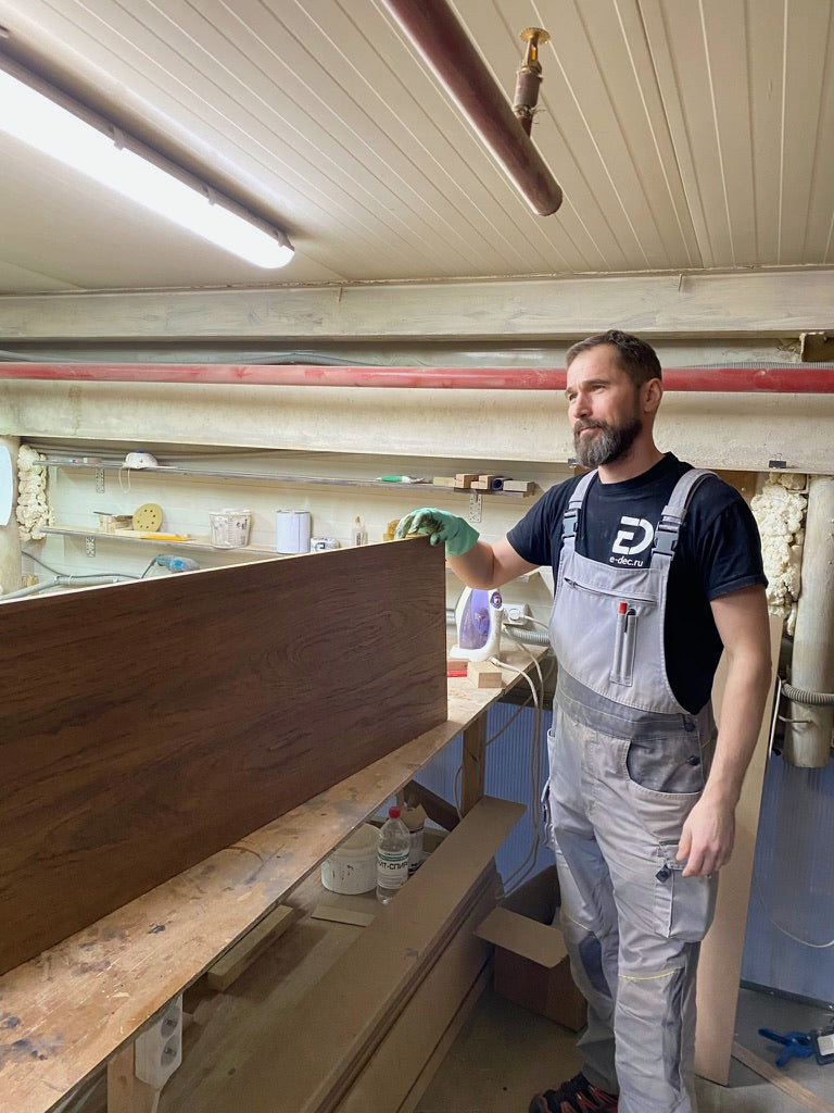 Andrew finishing a stained oak panel at the workbench