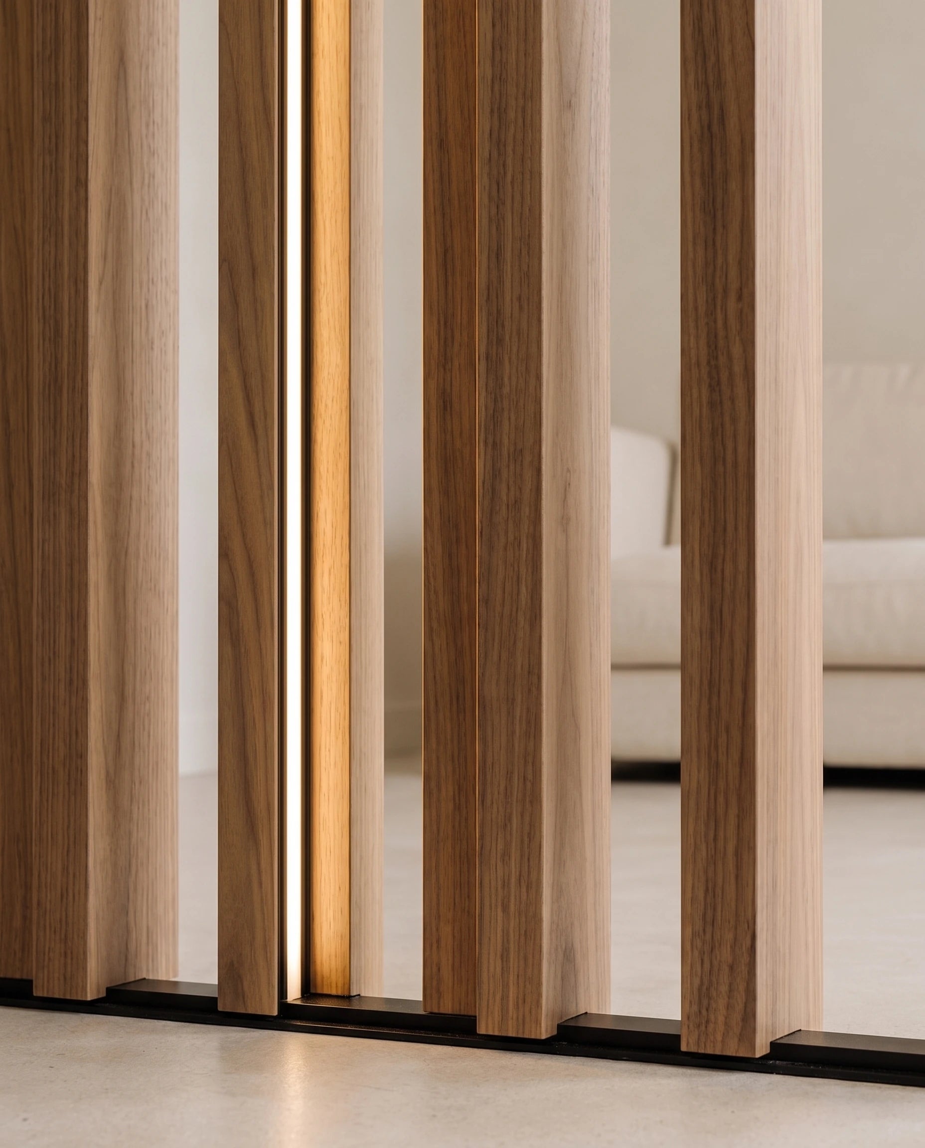 Warm side light recessed in a walnut room divider slat