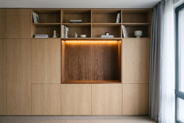 Floor-to-ceiling white oak built-in cabinetry with a lit walnut niche in a Los Angeles living room
