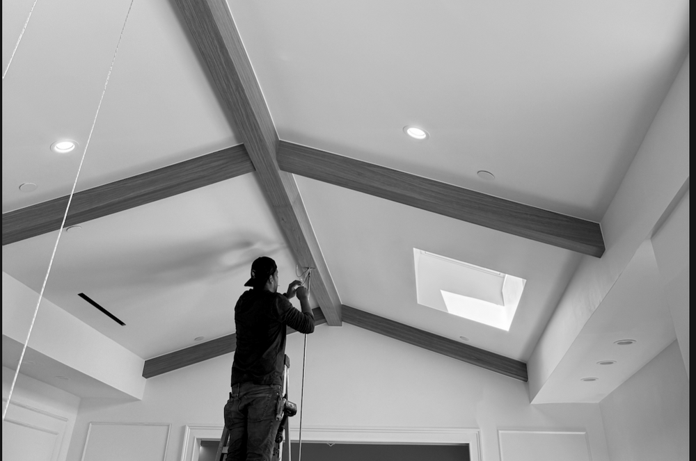 Installing clad wood ceiling beams in a Los Angeles home