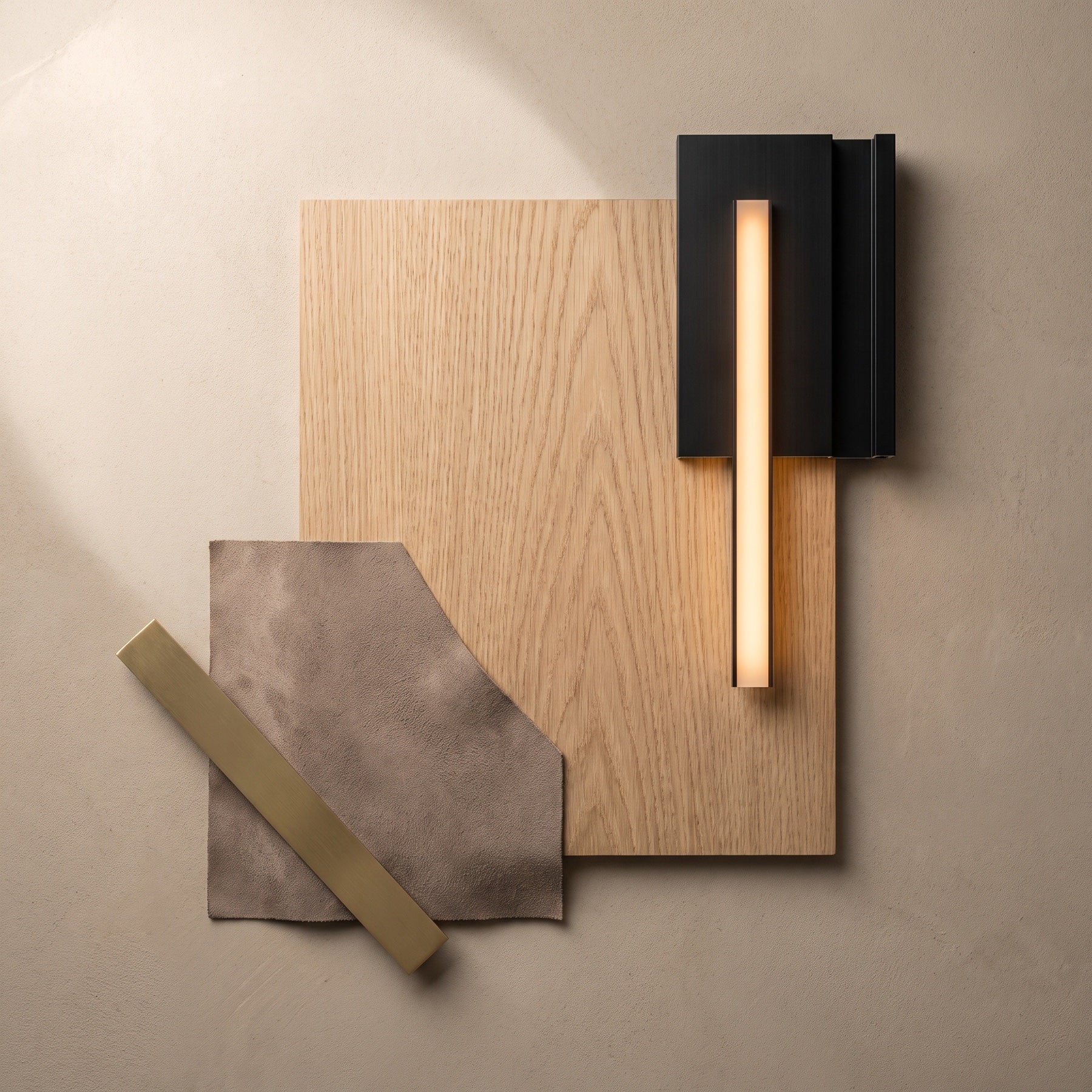 White oak, mushroom Alcantara, brushed brass, black profile and integrated warm light material palette